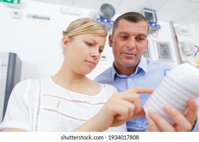 Woman Reading Chemical Container Label