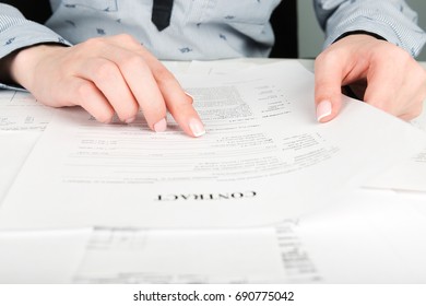 Woman Reading Contract Terms

