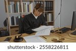 Woman reading documents in office wearing judge robe at desk with gavel and scales of justice in background.