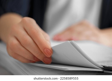 Woman reading documents at table in office, closeup. Space for text - Shutterstock ID 2258589555