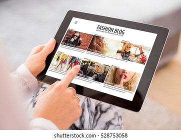 Woman reading fashion blog on tablet