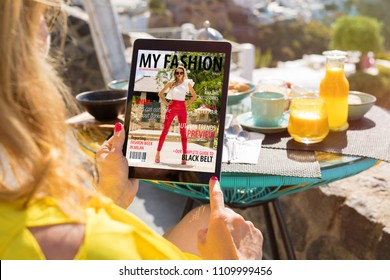 Woman Reading Fashion Magazine On Digital Tablet. All Contents Are Made Up.