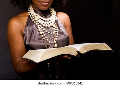 Woman reading isolated on black.