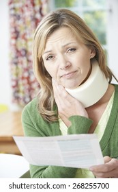 Woman Reading Letter After Receiving Neck Injury