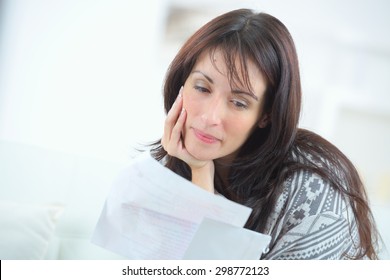 Woman reading a letter and smiling