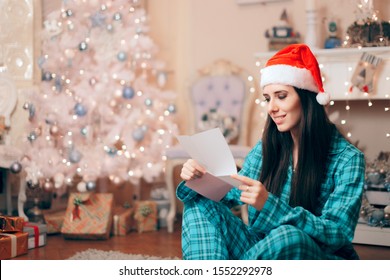 Woman Reading Love Letter Under The Christmas Tree. Xmas Girl Having Her Secret Wish List Ready For Santa Claus
