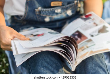 Woman Reading A Magazine Blur In Garden.