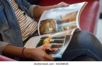 Woman Reading A Magazine Blur In Garden.