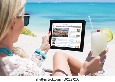 Woman Reading News On Tablet While Relaxing On The Beach. Contents Are All Made Up.