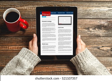 Woman Reading News On Tablet With Cup Of Coffee.