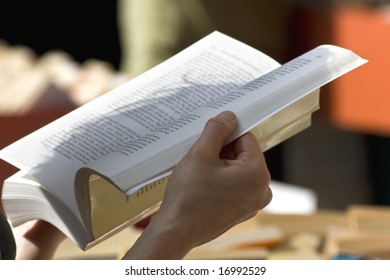 Woman Reading A Novel At Second Hand Book Store