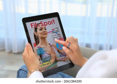 Woman Reading Online Magazine On Tablet Indoors, Closeup