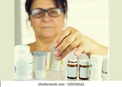 Woman Reading Prescription Bottle