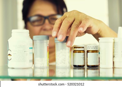 Woman Reading Prescription Bottle