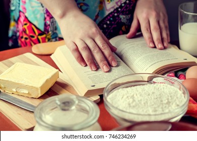 woman reading recipe book