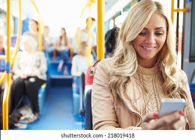 Woman Reading Text Message On Bus