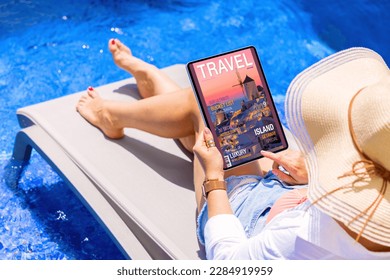 Woman reading travel magazine on tablet computer by the pool - Shutterstock ID 2284919959