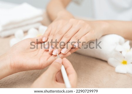 Woman receive care service by professional Beautician Manicure at spa centre. Nail beauty salon use nail file for Glazing treatment. manicurist make nail customer to beautiful. body care spa treatment