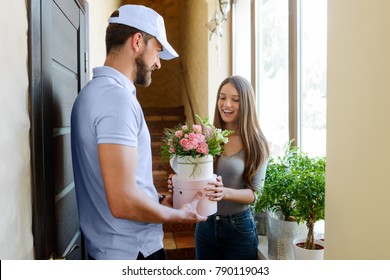 Woman Received Flowers, Ordered By Her Boyfriend. Bearded Deliveryman Giving Boxes With Bouquets To Her. Small Business, Local Flower Shop.