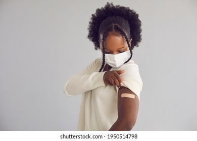 Woman Receives Covid 19 Vaccine Injection. Young Black Lady Showing Arm With Adhesive Plaster Bandage After Getting Vaccinated For Coronavirus. Vaccination Concept, Light Gray Copy Space Background