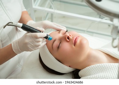 A woman receives laser treatment of the face in a cosmetology clinic, a concept of skin rejuvenation is being developed. laser peeling - Shutterstock ID 1963424686