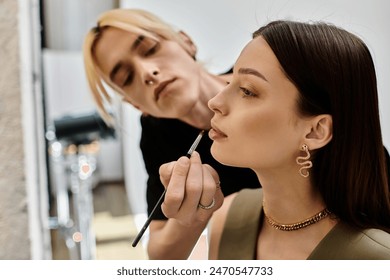A woman receives a professional makeup application from another woman.