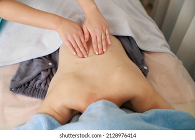 A Woman Receiving A Back Massage At An Esthetic Salon