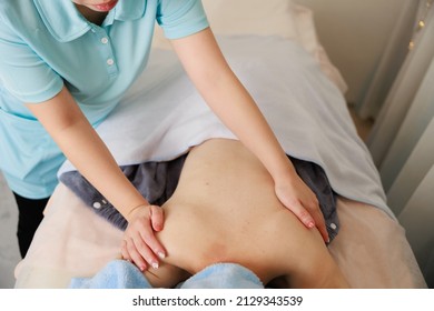 A Woman Receiving A Back Massage At An Esthetic Salon