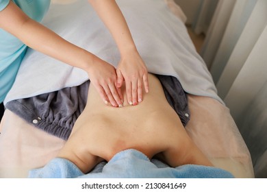 A Woman Receiving A Back Massage At An Esthetic Salon