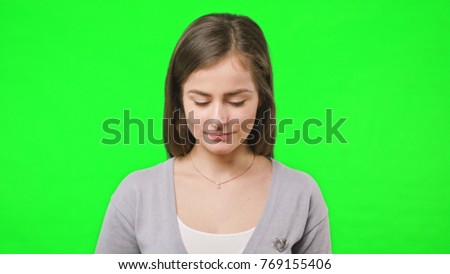 Woman receiving bad news on her phone slow motion on green screen background.