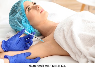 Woman Receiving Botox Injection In Armpit As Treatment Of Hyperhidrosis In Beauty Salon