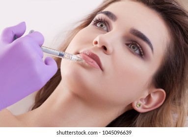 woman receiving a botox injection in her lips, close up