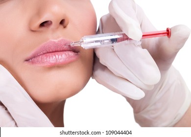 Woman Receiving A Botox Injection In Her Lips, Close Up