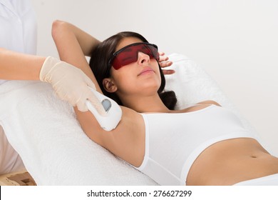 Woman Receiving Epilation Laser Treatment On Armpit At Beauty Clinic