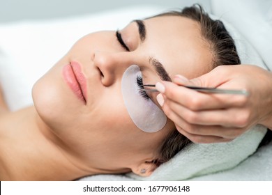 Woman receiving eyelash extension procedure close up. - Powered by Shutterstock