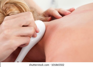 Woman Receiving Gua Sha Treatment On Neck