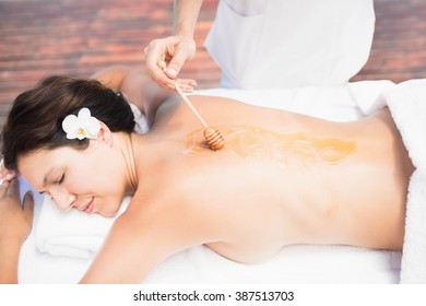 Woman Receiving A Honey Massage From Masseur Near Pool