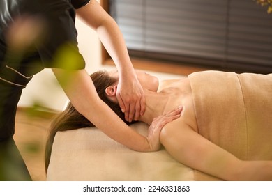 Woman receiving neck massage at beauty salon