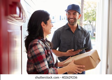 Woman Receiving Package From Courier At Home