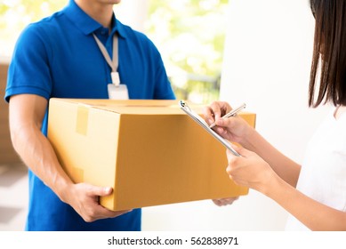 Woman Receiving Package From  A Delivery Man