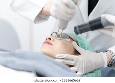 Woman receiving pico laser facial treatment in beauty Clinic.