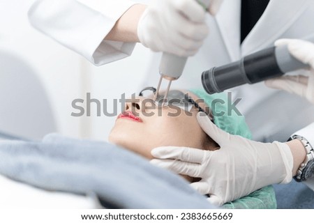 Woman receiving pico laser facial treatment in beauty Clinic.