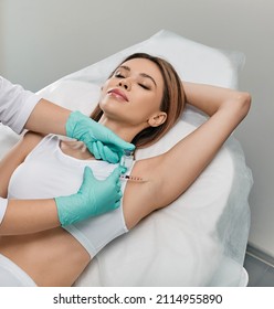 Woman Receiving Underarm Hyperhidrosis Treatment. Armpit Injections To Prevent Excessive Sweating With Beautician At Cosmetology