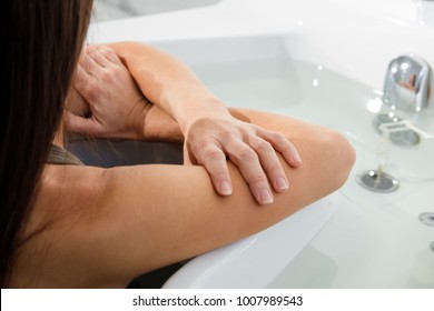  Woman Receiving Water Procedures In Spa Salon. Female Patient On Hydrotherapy. Soft Focus On Hands. Copy Space