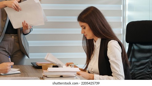 Woman Receiving Work During A Meeting With Boss And Collegue. Calm Modern Working Environment Leading To Work Well Done. Team Analysing Data In Office.