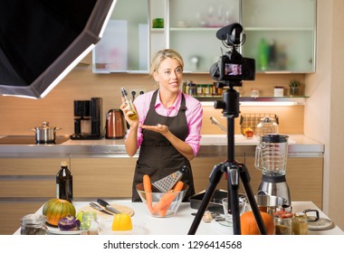 Woman Recording Video In Her Home Kitchen, Creating Content For Video Blog