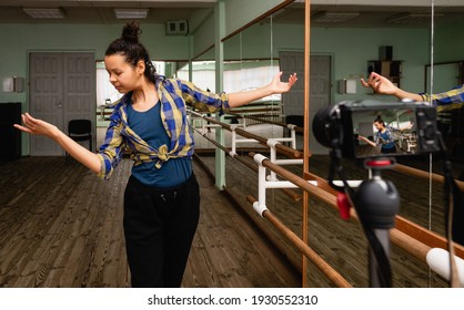 Woman Records A Video Lesson Of Dancing From The Choreography Hall. Pretty Young Woman Vlogger Showing Dance Move.