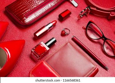 Woman red accessories, jewelry, cosmetic, shoes and other luxury objects on leather background, fashion industry, modern female concept, selective focus 