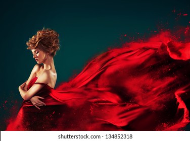 Woman in red blowing flying red dress dissolving in splash