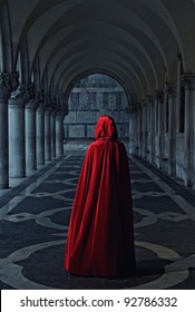 Woman In Red Cloak Walking Away